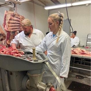 Butcher Block Custom Cutting team processing meat at the facility